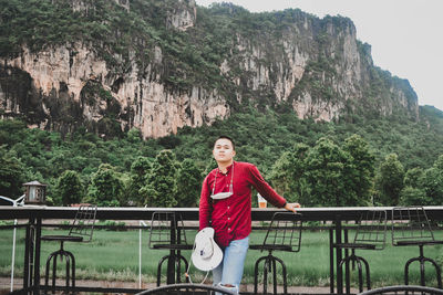 Portrait of man standing on rock