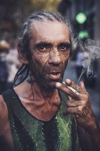 Close-up portrait of man smoking cigarette