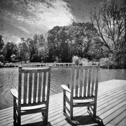 Chairs and trees against sky