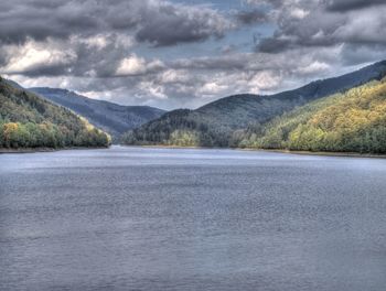 Scenic view of lake against cloudy sky