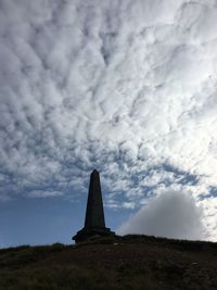 Low angle view of old ruin against cloudy sky