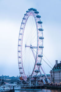 Low angle view of ferris wheel in city