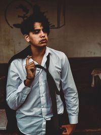 Thoughtful young man looking away while standing outdoors