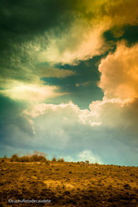 Low angle view of dramatic sky over land