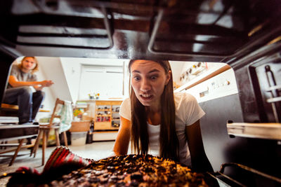 Portrait of a young woman working on table