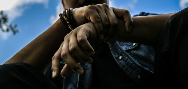 Midsection of couple holding hands