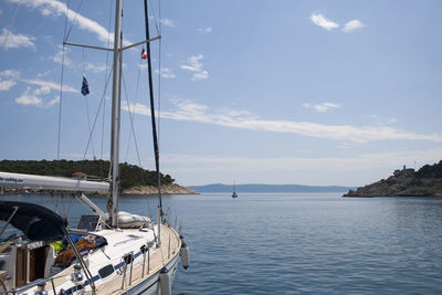 Sailboats in sea against sky