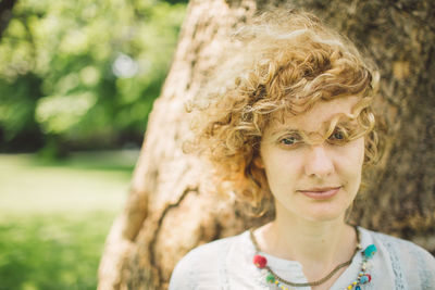 Portrait of smiling young woman with curly blond hair