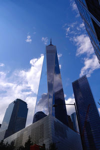 Low angle view of one world trade center against sunny sky