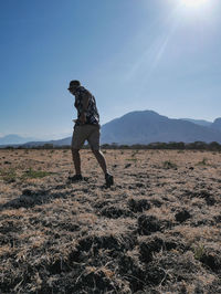 Man standing on mountain against sky