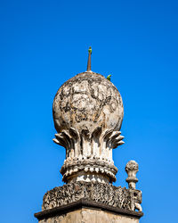 Low angle view of statue against blue sky