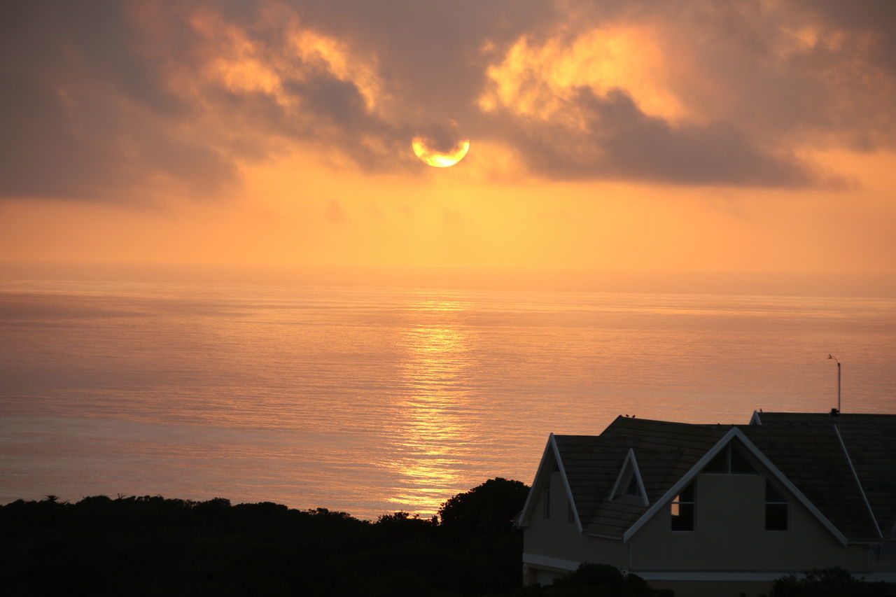 SCENIC VIEW OF SILHOUETTE HOUSE AGAINST SKY AT SUNSET