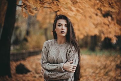 Portrait of young woman standing outdoors