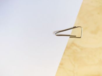 High angle view of cross on table against white background