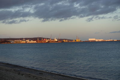 Harbour  by sea against sky at sunset