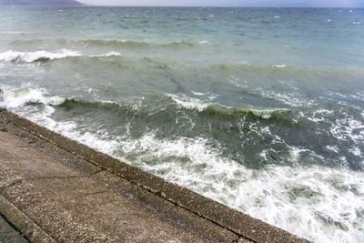 High angle view of waves rushing towards shore