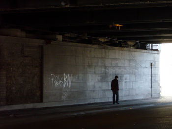 Rear view of man walking in corridor