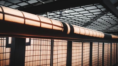 Close-up of illuminated window. pipe and rail