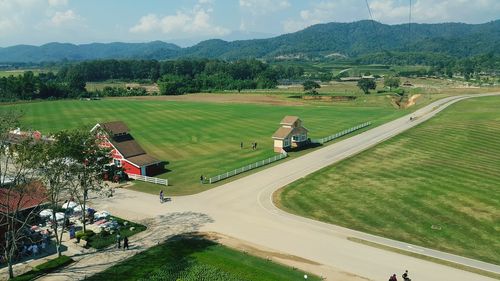 High angle view of golf course on field against sky