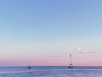 Sailboat sailing in sea against sky