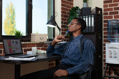 Businessman looking at laptop in office