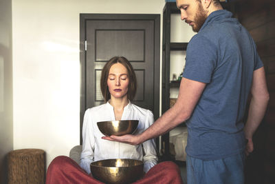 Young man and woman standing on glass