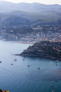 High angle view of sea by cityscape against sky