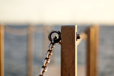 Close-up of chain railing at harbor