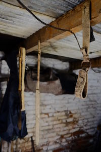 Close-up of rusty metal hanging on roof of building