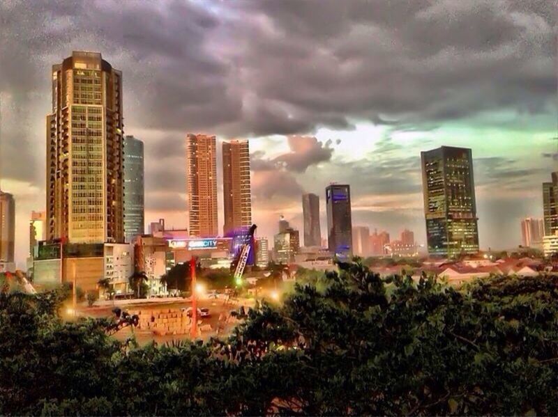 building exterior, architecture, sky, built structure, cloud - sky, city, skyscraper, cloudy, cityscape, urban skyline, modern, weather, office building, tall - high, building, cloud, tower, storm cloud, residential building, overcast