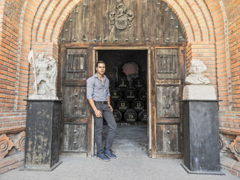 Portrait of man standing at wine cellar entrance