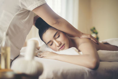 Young woman being massaged on table in spa