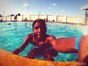 Portrait of shirtless man in swimming pool