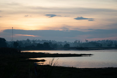 Scenic view of lake against sky during sunset