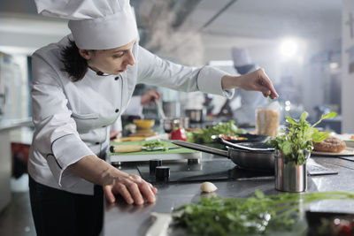 Midsection of man preparing food at home