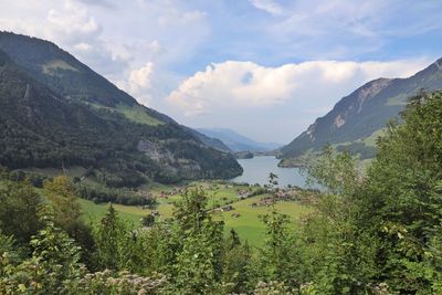 Scenic view of lake and mountains against sky