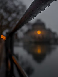 Close-up of illuminated chain against sky at dusk