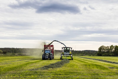 Tractor on field against sky