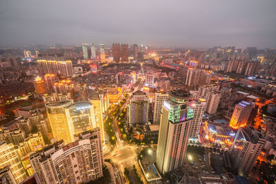 High angle view of illuminated city buildings at night