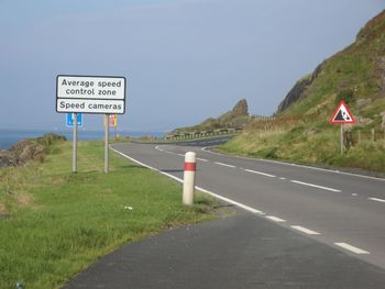 View of road sign against sky