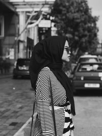 Woman in hijab standing on street