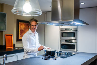 Portrait of smiling man standing at home