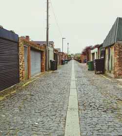 Empty alley amidst buildings in city