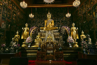 Statue in illuminated building at temple