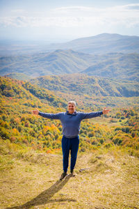 Rear view of man standing on mountain