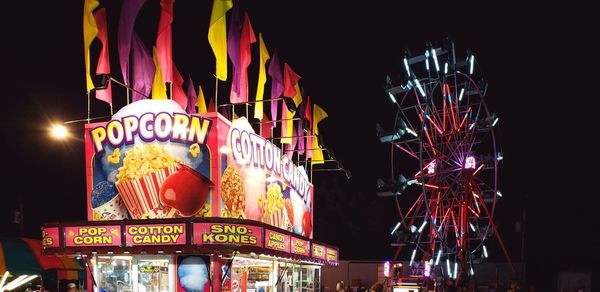 Low angle view of illuminated ferris wheel at night