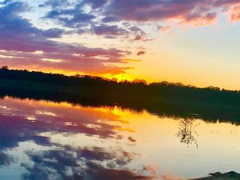 Scenic view of lake against orange sky