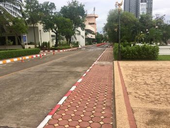 Empty road by street in city