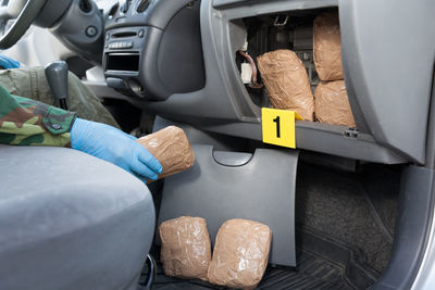 Midsection of person sitting in car