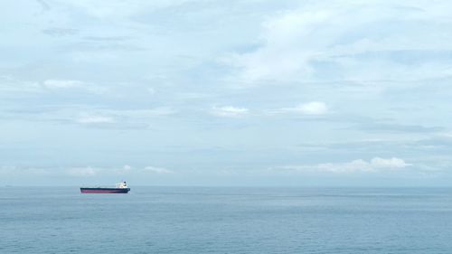 Boat sailing in sea against sky